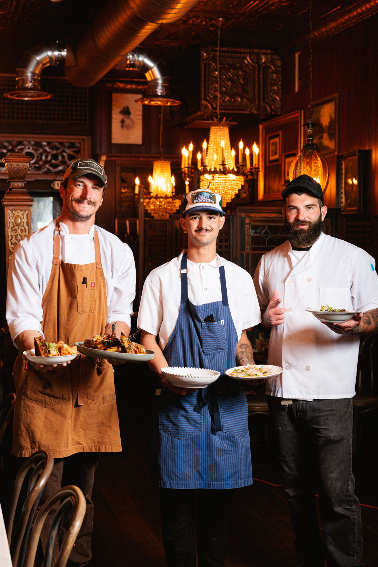 Chefs presenting dishes in restaurant.